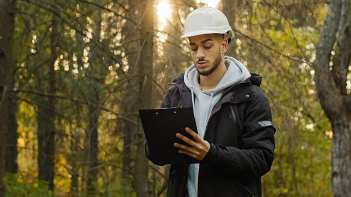 Man in hard hat looking at tablet