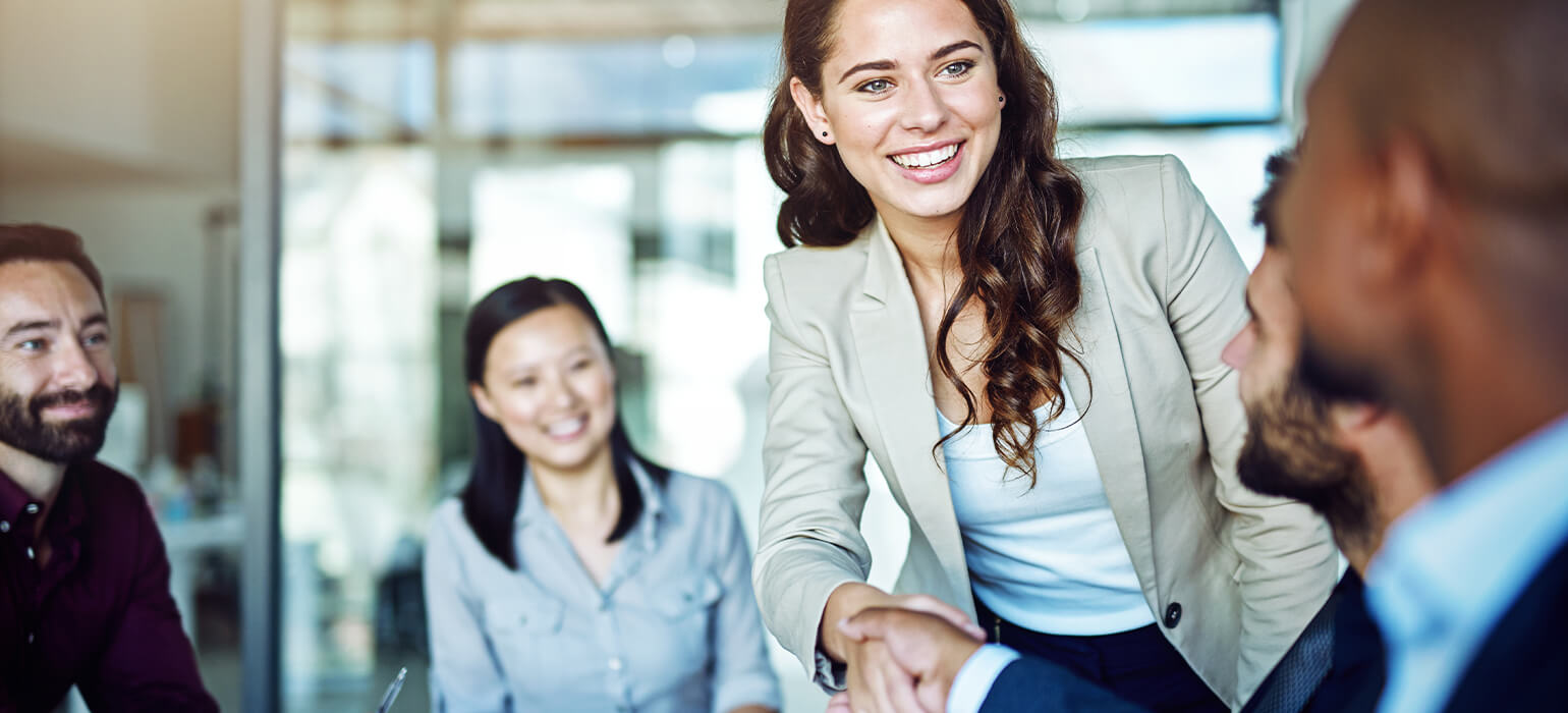 Professionals shaking hands at a table