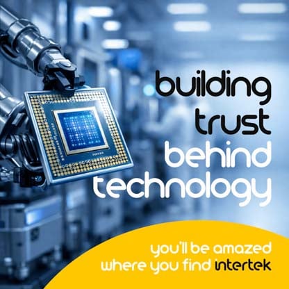 A computer chip held by a robot arm in a lab