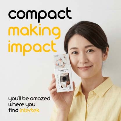 A woman holding a box containing a Shupatto makeup bag