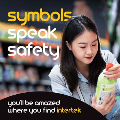 A woman in a grocery store reading the label on a bottle