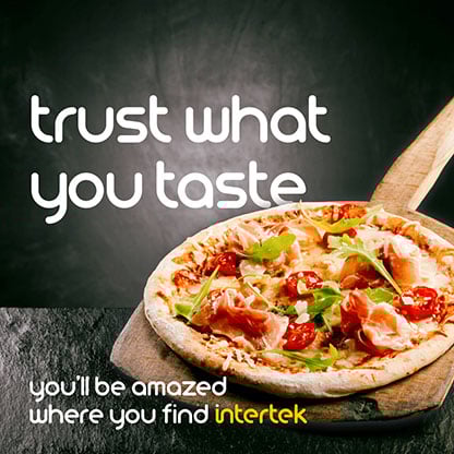 A freshly-cooked pizza on a serving paddle