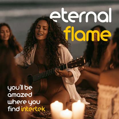 A woman playing guitar by candlelight at the beach with her friends